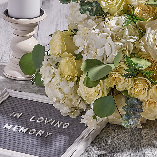 Sympathy flower arrangement with neutral tones